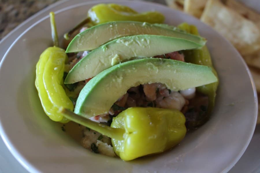 The ceviche ($12.25) is made with salmon, tilapia, shrimp, cilantro and red onions and is served with pepperoncinis and fried tortilla chips. (Eva Vigh/Community Impact Newspaper)