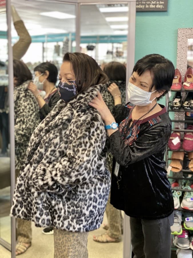 Owner Suki Mourlam helps style a customer at the boutique. (Courtesy Closet Revival)