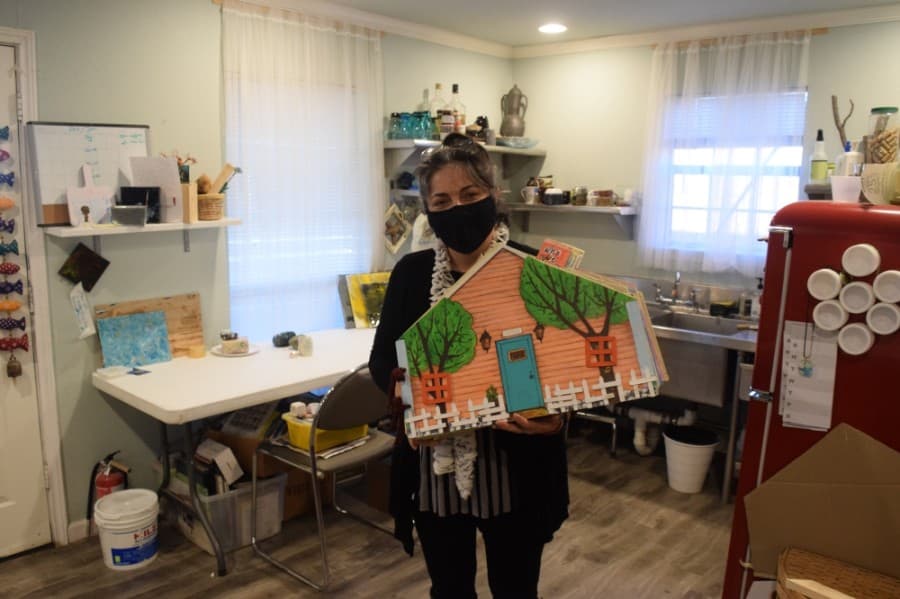 Nazanin Ahmady holds a handmade scrapbook detailing the history of Junction Arts. (By Matt Payne)
