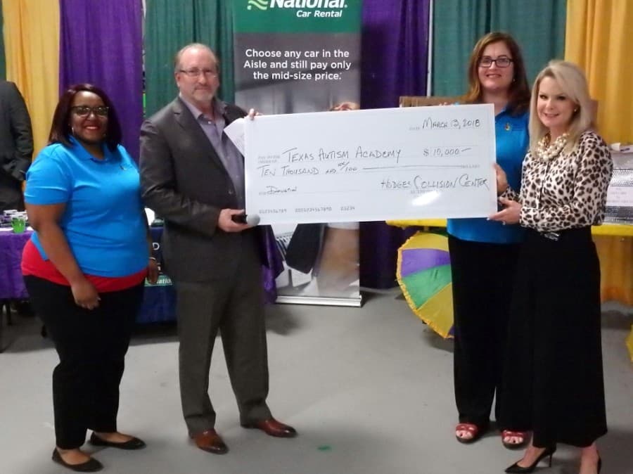 From left, Texas Autism Academy founder Shelinta Perez, supporter Steve Guinn, founder Cary Mollinedo and supporter Deborah Guinn hold a check from a scholarship fundraiser. (Courtesy Texas Autism Academy)