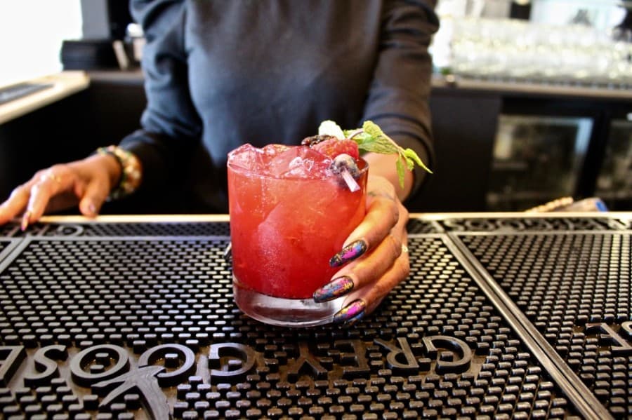 At the bar: Bourbon Kiss ($15) featuring kiwi syrup, lemon juice and muddled berries
