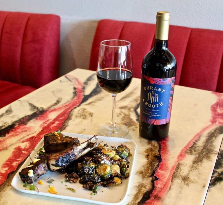 At the table: lamb chops with Brussels sprouts ($28) and a bottle of Durant & Booth Cabernet ($53)