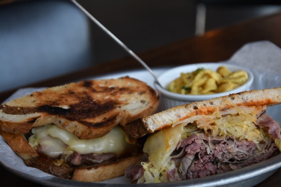 Smoked Reuben features smoked pastrami, sauerkraut and swiss cheese on toasted marbled rye. $16.50. (Hunter Marrow/Community Impact Newspaper)