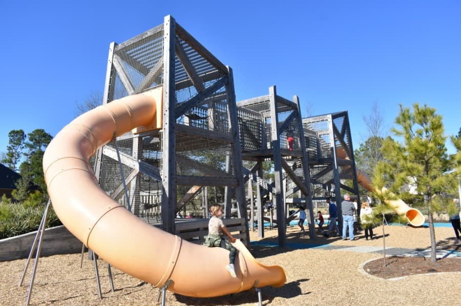 Among the amenities at Pine Cove Park are a large slide and jungle gym, swings and other activities for children. (Vanessa Holt/Community Impact Newspaper)