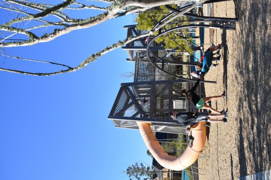 Among the amenities at Pine Cove Park are a large slide and jungle gym, swings and other activities for children. (Vanessa Holt/Community Impact Newspaper)