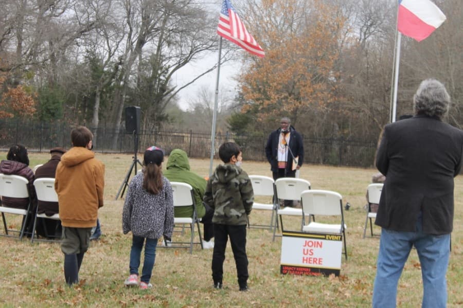 Local teacher Kerry Madison (front of the audience) opens the sacred walk event at Ross Cemetery. (Courtesy Legacy Keepers of Old East McKinney)