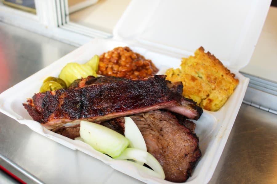 The 2 Meat Plate ($18) features a patron’s choice of brisket, pork ribs, sausage or chicken paired with two sides, such as jalapeno corn spoonbread and baked beans. The truck also offers one- and three-meat plates. (Kelly Schafler/Community Impact Newspaper)