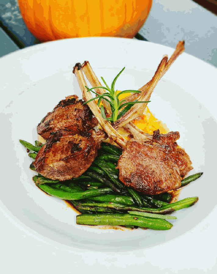 Dijon and rosemary-crusted Australian rack of lambs is served with scalloped potatoes and basil green beans. Spicy beef and vegetable ramen is served with a soft-boiled egg. (Courtesy Didi's Downtown)