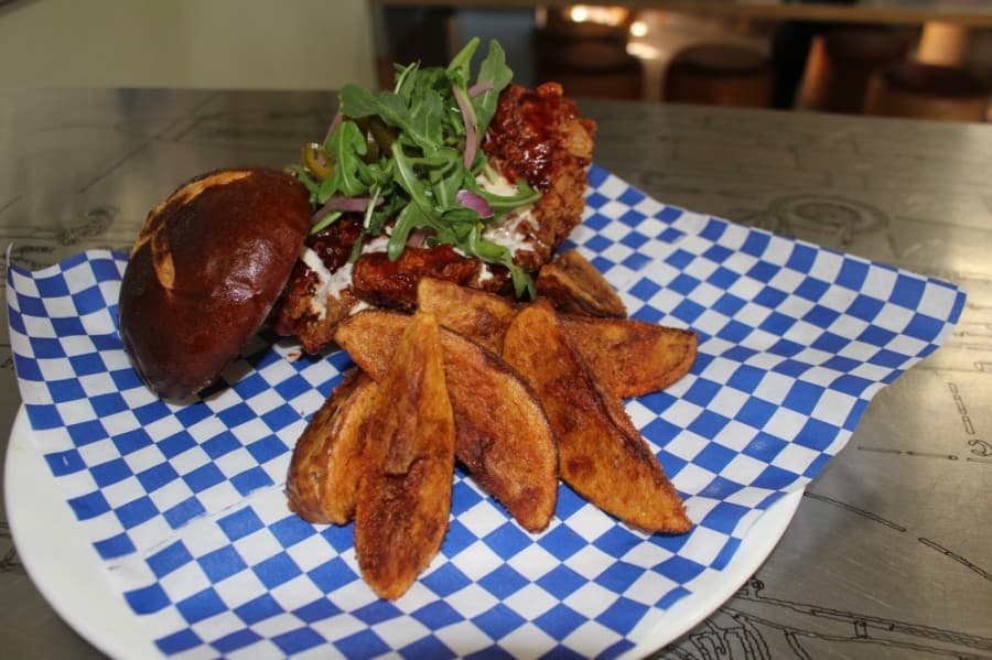 The Chicken Sandwich ($11) is topped with homemade habanero honey sauce and served with in-house made fried. (Eva Vigh/Community Impact Newspaper)