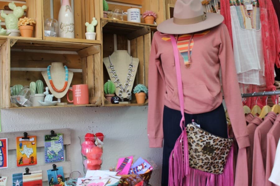 The boutique offers custom-designed apparel in addition to accessories. (Adriana Rezal/Community Impact Newspaper)