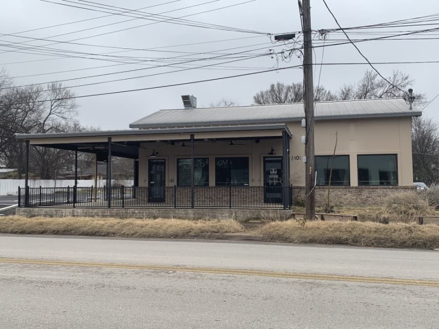 Photo of an empty brown builidng from the street