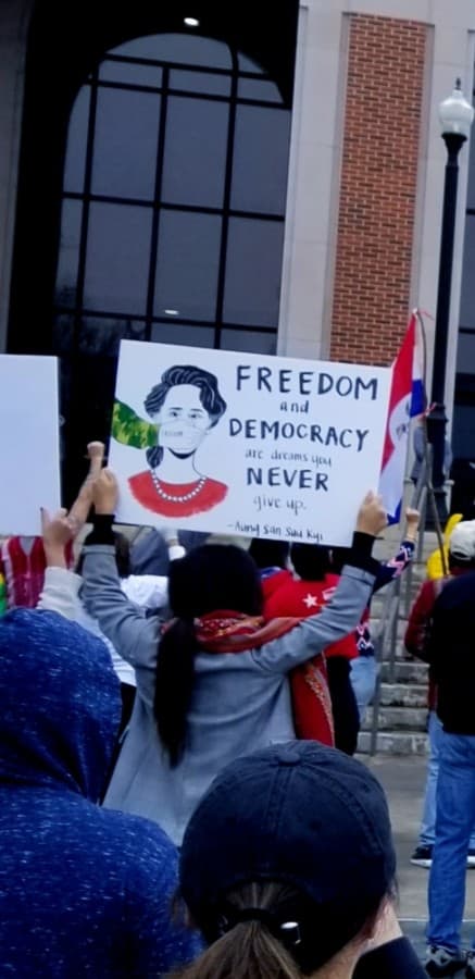 Protesters raise pro-democracy signs at the Feb. 27 protest on the steps of Lewisville City Hall. The event was organized in opposition to the military coup that occurred in Myanmar earlier that month. (Aubrey Galloway/Community Impact Newspaper)