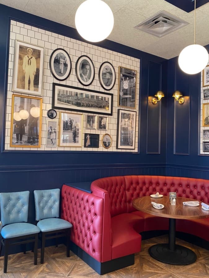 The owner's family photos line the subway-tiled walls of the dining room. (Phyllis Campos/Community Impact Newspaper)