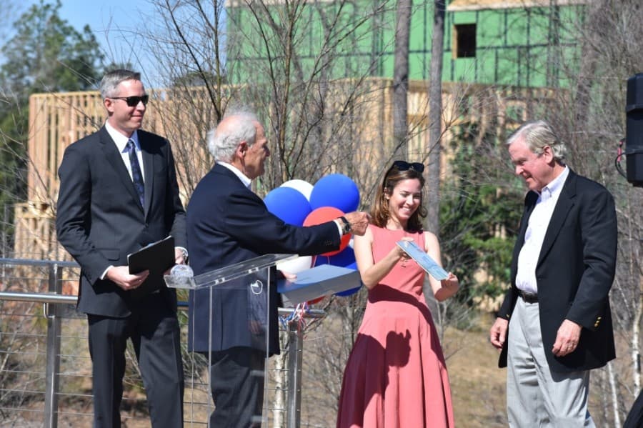 Robert Heineman was presented with a drawing by his daughter, Amanda, in the tradition of the caricatures he has himself created for retirees. (Vanessa Holt/Community Impact Newspaper)