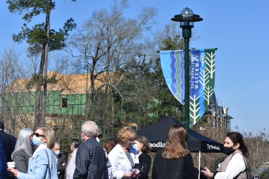 Area officials gathered at The Woodlands Waterway on March 8 to dedicate a pedestrian bridge to Robert Heineman. (Vanessa Holt/Community Impact Newspaper)