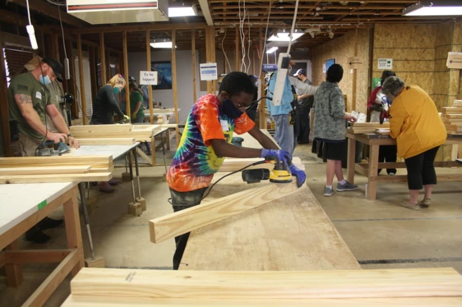Volunteers work together to build beds for local children. (Danica Lloyd/Community Impact Newspaper)