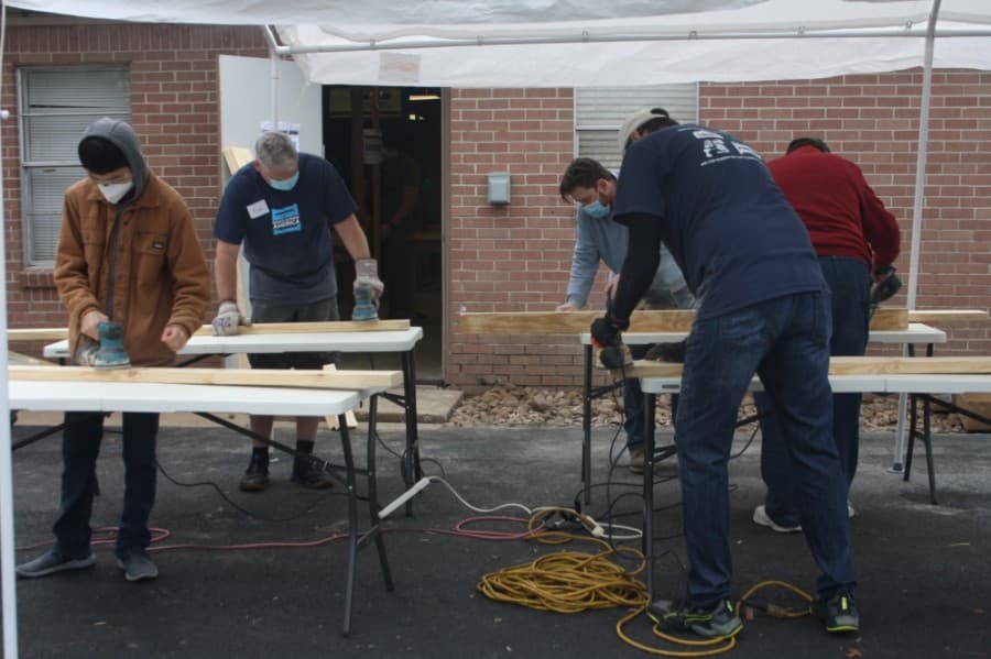 Volunteers work together to build beds for local children. (Danica Lloyd/Community Impact Newspaper)