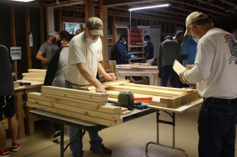 Volunteers work together to build beds for local children. (Danica Lloyd/Community Impact Newspaper)
