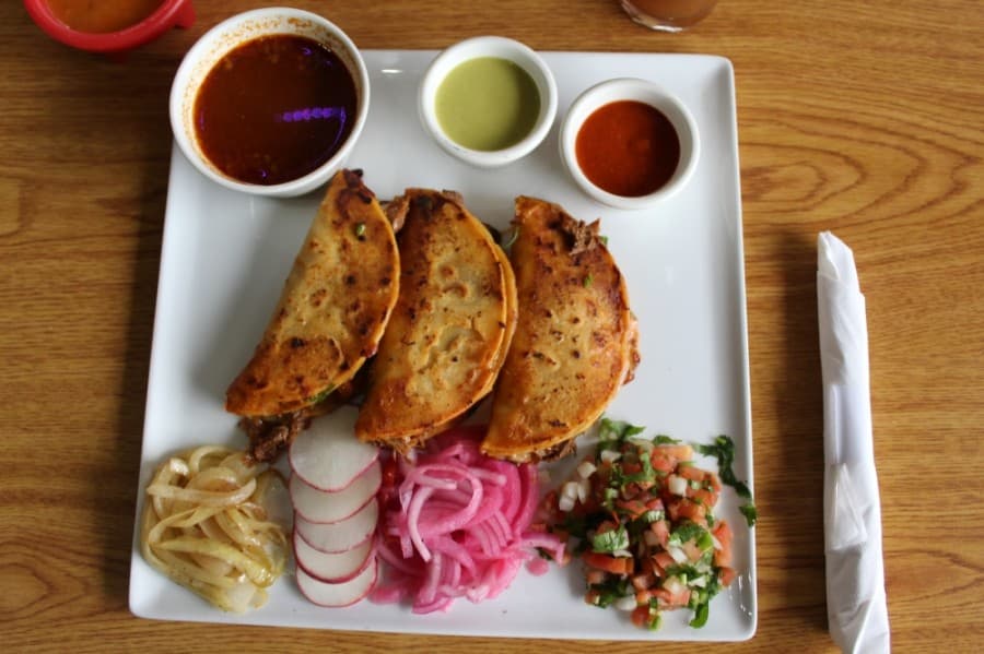 Tacos de Birria ($12.99): Tough cuts of beef are cooked until tender with chiles and Mexican spices, served with pico de gallo, lightly corn toasted totillas and cheese. (Shawn Arrajj/Community Impact Newspaper)