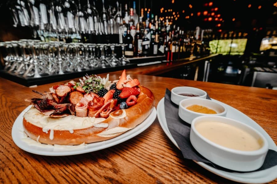 


The Texas charcuterie board ($18) is served in a Bavarian pretzel with sliced brisket, sausage, capicola, cheese, fruit, olives and gouda cheese sauce.
