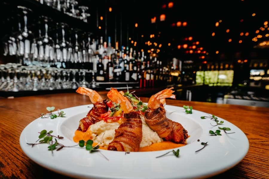


The jumbo bacon-wrapped shrimp and grits ($21) are part of the brunch menu and are stuffed with crab and served with Creole butter sauce.