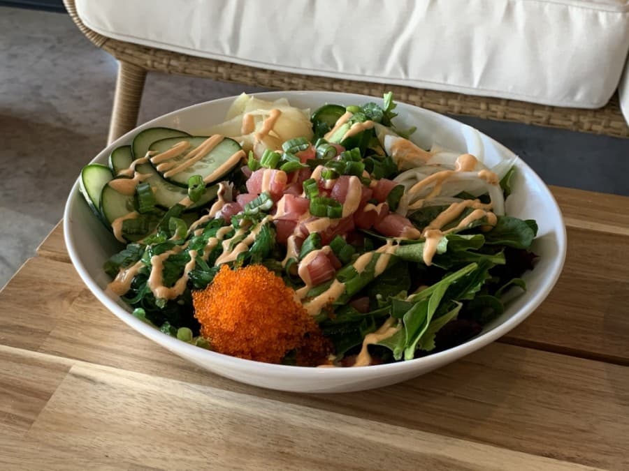 Poke bowls can be built to order using ingredients like Ahi tuna, cucumber and Masago.