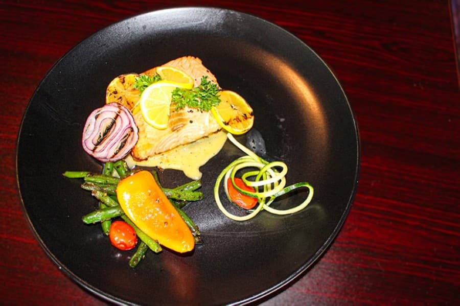The redfish is served with vegetables as a main dish option. (Eva Vigh/Community Impact Newspaper)