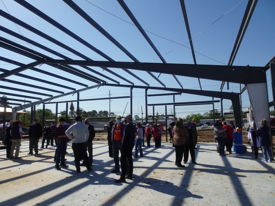Cypress Assistance Ministries employees, board members and community partners were invited to leave messages and signatures on a beam in the organization's new building March 26. (Danica Lloyd/Community Impact Newspaper)