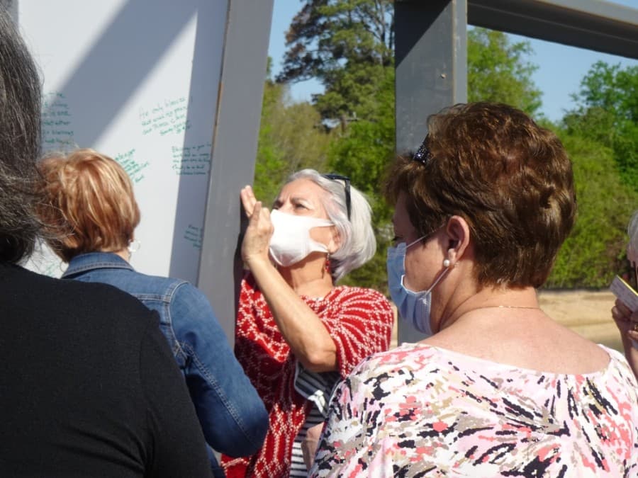 Cypress Assistance Ministries employees, board members and community partners were invited to leave messages and signatures on a beam in the organization's new building March 26. (Danica Lloyd/Community Impact Newspaper)