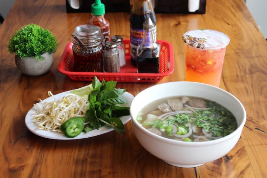 A staple dish in Vietnamese cuisine, pho is a bone broth noodle soup served with meat and vegetables. The combination pho ($10.99) is served with beef and pork meats. (Adriana Rezal/Community Impact Newspaper)