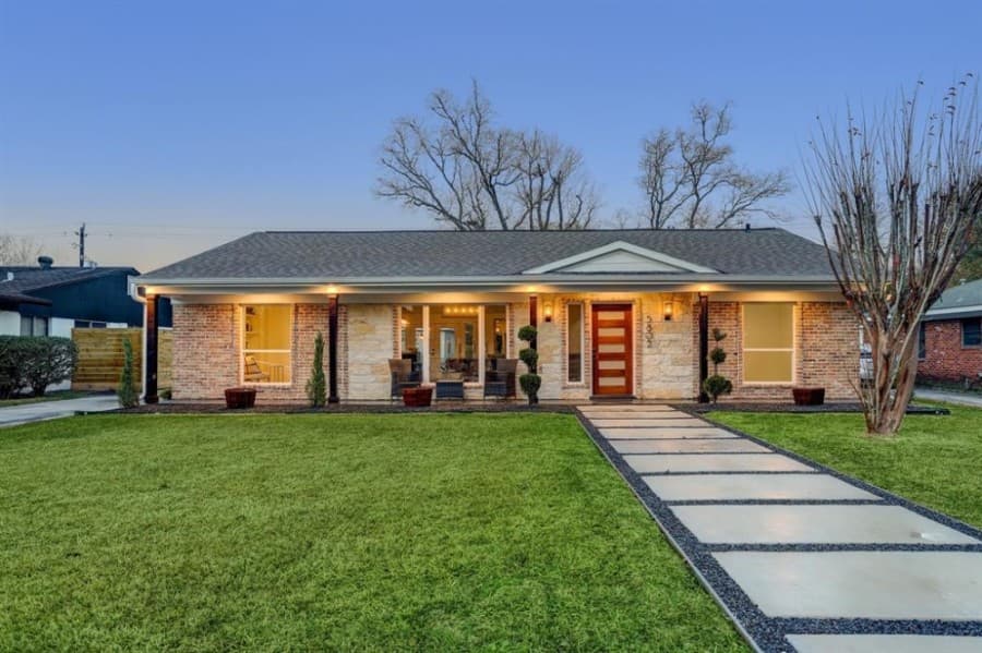 5802 Bankside Drive, Houston: A traditional-styled home built in 1963, this home has extensive renovations throughout and includes engineered wood floors; 12-foot, exposed, wood-beam ceilings in the living and dining rooms; and raised ceilings. The home also features sliding barn doors and a kitchen with subway tile backsplash and an ebony-hued quartz waterfall island with a breakfast bar. Glass patio doors lead to an expansive tiled patio, an outdoor kitchen area and a landscaped yard. 3 bed, 2 full and 1 half-bath/2,000 sq. ft. Sold for $482,001-$552,000 on March 15. (Courtesy Houston Association of Realtors)