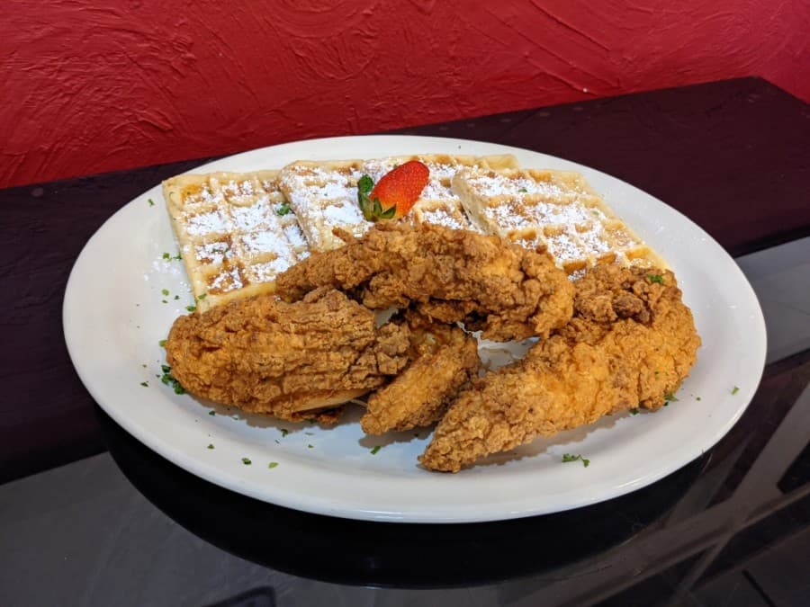 The Chicken & Waffles features three hand-battered chicken tenders and homemade buttermilk waffles. (Photos by Jake Magee/Community Impact Newspaper)