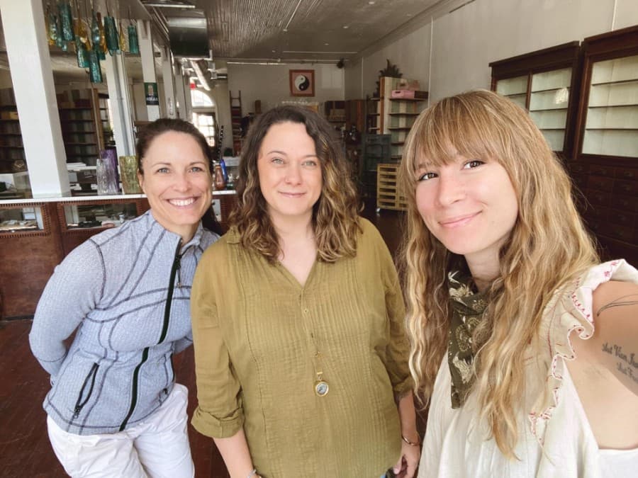 Zoi Market Owner Noa Lynne Sutherland (center) and General Manager Abigayle Peka-Stansberry (right) stand in the store's new location with Willow Gardens Juicery Owner Raelynn Deaton-Haynes (left), whose products will be sold in the health and wellness market. (Courtesy Zoi Market)