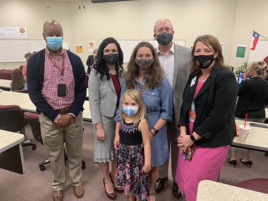 Photo of a group of people with masks on