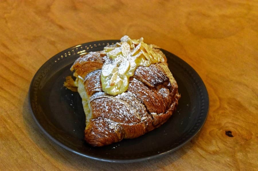 The almond croissant features a rich, frangipane filling and is dusted with sugar and almonds. (Matt Payne/Community Impact Newspaper)