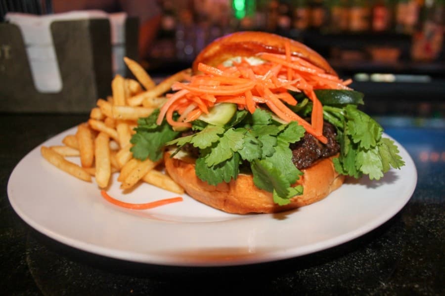 The Bark Mi Burger ($13.99) is inspired by the Vietnamese dish banh mi and includes jalapenos, cilantro, carrots and cucumbers.(Andy Li/Community Impact Newspaper)