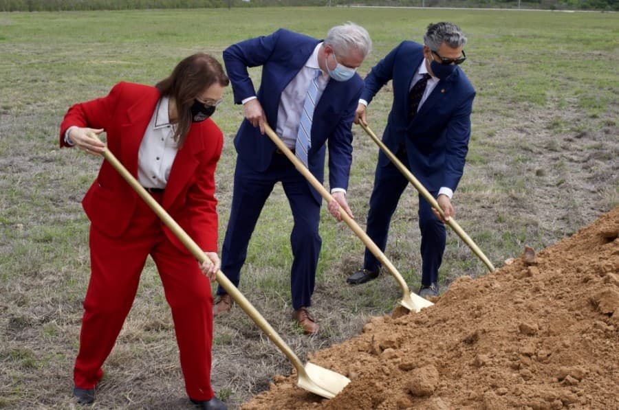 Left to right: Mayor Jane Hughson, Goodblend President Marcus Ruark and Hays County Judge Ruben Becerra shovel dirt during a groundbreaking ceremony in San Marcos on April 19. (Warren Brown/Community Impact Newspaper)