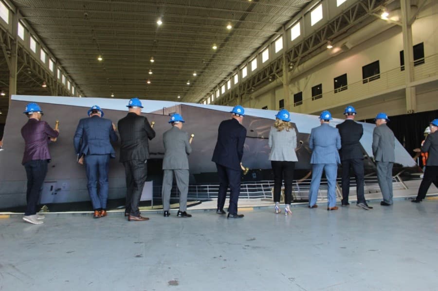 Frisco officials knock over the dummy wall to reveal the new space for Frisco's library. (Miranda Jaimes/Community Impact Newspaper)