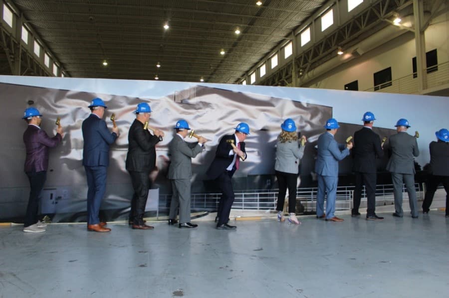 Frisco officials prepare to knock over the dummy wall to reveal the new space for Frisco's library. (Miranda Jaimes/Community Impact Newspaper)