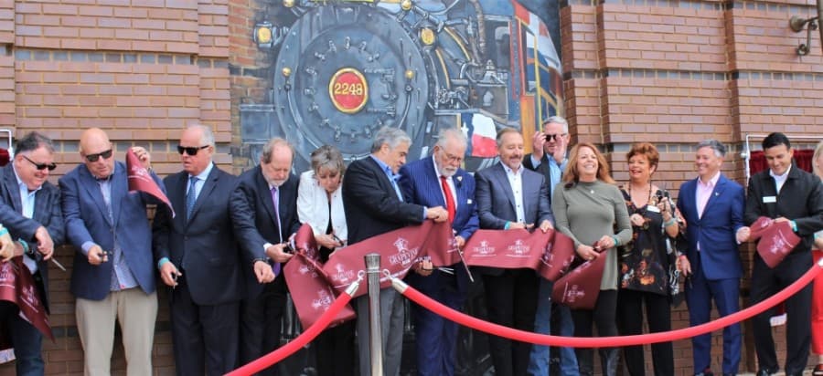City council members and city staff cut the ribbon marking the official grand opening of Grapevine Main Station on April 24, 2021. (Sandra Sadek/Community Impact Newspaper)