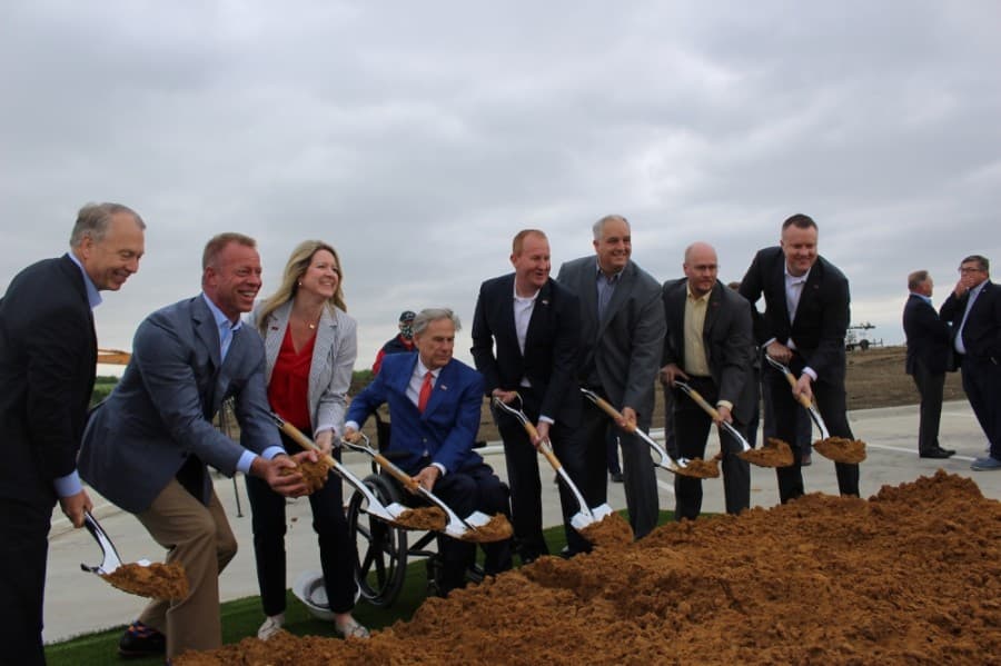 Frisco City Council gathers for a photo with Gov. Greg Abbott, fourth from left, during the May 4 groundbreaking for the Omni PGA Frisco Resort. (Miranda Jaimes/Community Impact Newspaper)
