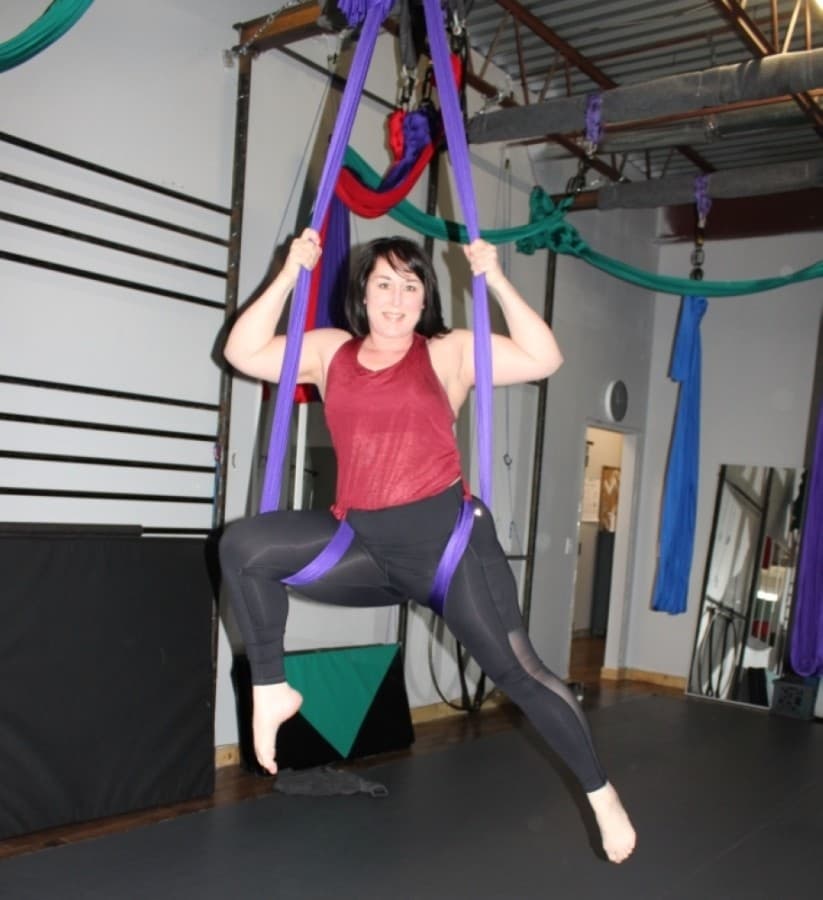 woman hanging on silk ropes