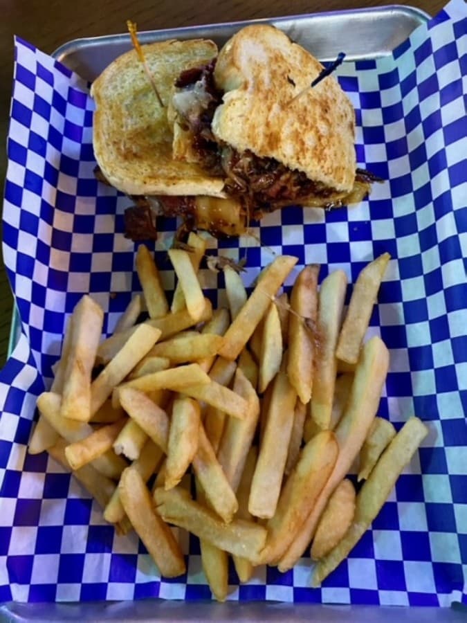Not Just a Grilled Cheese Sandwich ($9.95) includes smoked brisket, American, Swiss and cheddar cheese, and nacho chili barbecue sauce served on sourdough bread with a side of fries. (Yvonne Brown/Community Impact Newspaper)