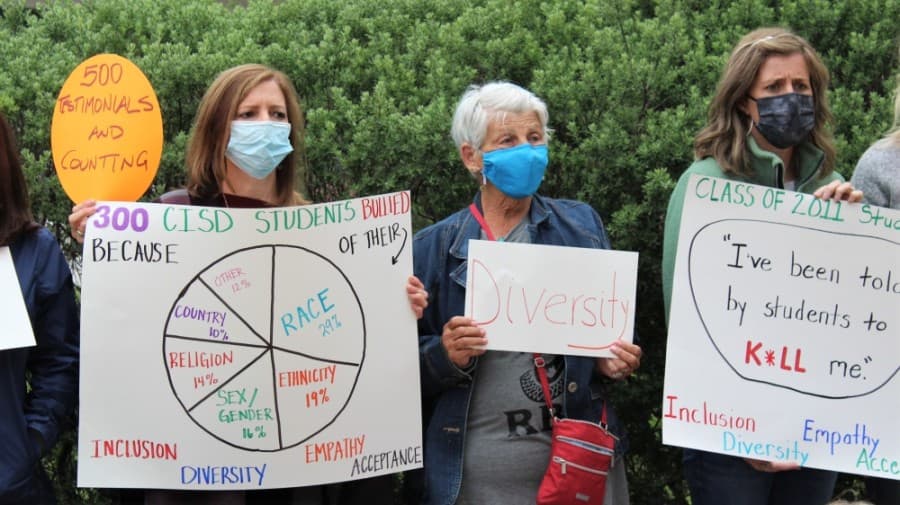 people holding signs