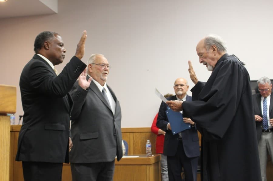 Incumbents Charles Cunningham (left) and Charles "Andy" Curry (right) took the oath of office for places 2 and 1, respectively. (Kelly Schafler/Community Impact Newspaper)