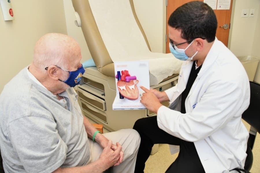 Jose Condado Contreras, MD, discusses the benefits of a device implant procedure with a potential candidate in the Cardiology Clinic at Baylor Scott & White Medical Center – Round Rock.