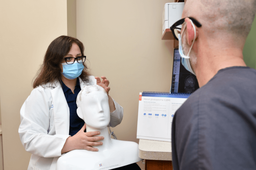 Neuro-oncologist Danijela Levacic, MD, discusses new technology used to treat brain cancer with a patient at Baylor Scott & White Cancer Center – Round Rock.