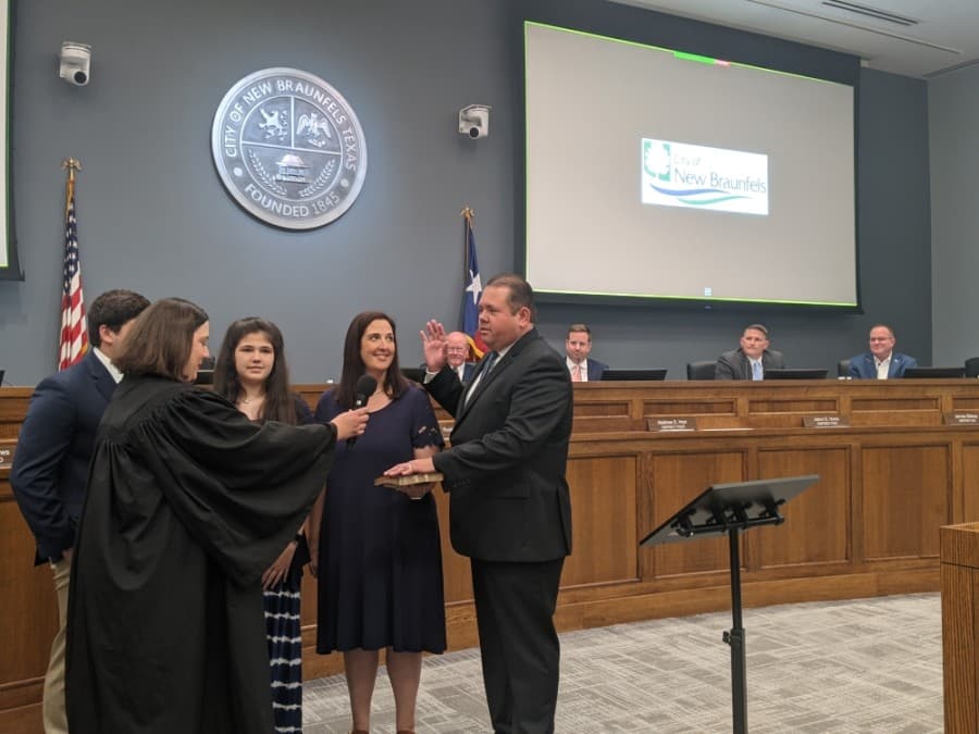 man taking oath while others watch