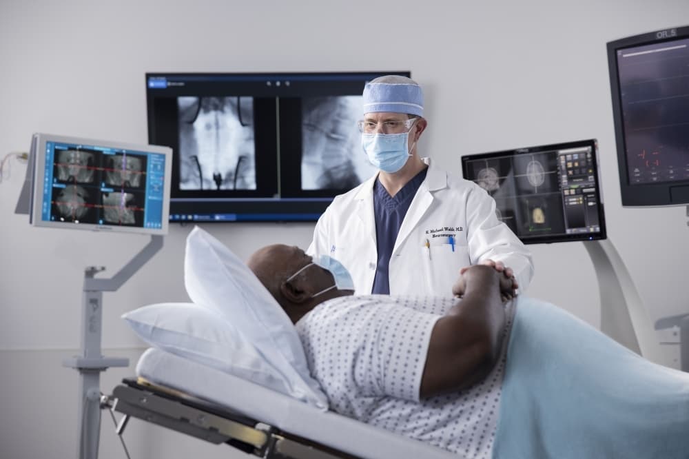 doctor standing over patient 