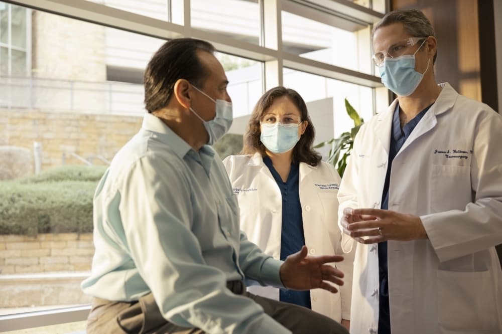 doctors and patients sitting by a window